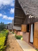 a building with a pathway next to a building with a roof at Soanala in Moramanga