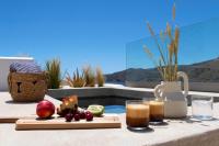 a table with a tray of food and a drink at Elesia Boutique Hotel in Livadi Astypalaias