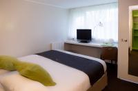 Un pat sau paturi &icirc;ntr-o camer&#x103; la Hotel inn Design Laval