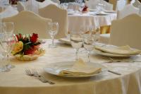 a table with plates and wine glasses on it at Royal Hotel Montevergine in Ospedaletto dʼAlpinolo