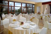 a banquet hall with white tables and white chairs at Royal Hotel Montevergine in Ospedaletto dʼAlpinolo