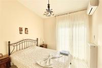 A bed or beds in a room at Helios Villa Sea Front - 3 bedrooms 7 guests