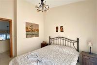 A bed or beds in a room at Helios Villa Sea Front - 3 bedrooms 7 guests