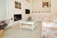 A television and/or entertainment centre at Helios Villa Sea Front - 3 bedrooms 7 guests