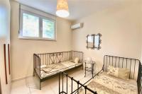 A bed or beds in a room at Helios Villa Sea Front - 3 bedrooms 7 guests