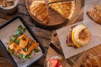 una mesa cubierta con diferentes tipos de comida y pan en Hotel Champlain Burlington, Curio Collection by Hilton, en Burlington