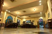 an empty room with tables and chairs in a building at Hotel Rime Vista in Jaipur