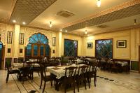 a restaurant with tables and chairs in a room at Hotel Rime Vista in Jaipur