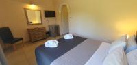 Posteľ alebo postele v izbe v ubytovaní Paleo Inn Hotel