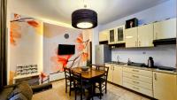 a kitchen with a table and a dining room at ŽUPAN apartmani in Soko Banja