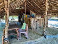 a table and chairs in a hut on the beach at Nilana beach cabana in Panama