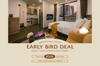 a hotel room with a bed and a laptop on a table at The Bloom Pham Viet Chanh - Modern Living Space in Saigon - A Top Choice for Western Travelers in Ho Chi Minh City