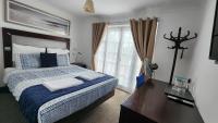 a bedroom with a large bed and a window at Gatwick Castle B&B in Horley