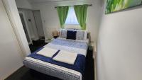 a small bedroom with a bed and a window at Gatwick Castle B&B in Horley
