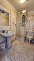 a bathroom with a sink and a shower and a toilet at Gatwick Castle B&B in Horley