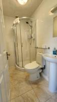 a bathroom with a shower and a toilet and a sink at Gatwick Castle B&B in Horley
