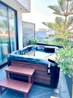 a jacuzzi tub with a bench in a house at Hotel Joni Premium in Ksamil