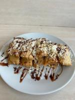 a white plate with a piece of food with chocolate at The volcano in Kubupenlokan