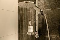 a shower in a bathroom with a bottle of soap at Motel One Salzburg-Mirabell in Salzburg