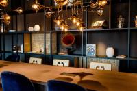 a dining room with a wooden table and chairs at Motel One Salzburg-Mirabell in Salzburg