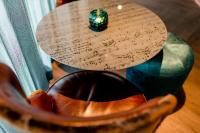 a wooden table with a table with music on it at Motel One Salzburg-Mirabell in Salzburg