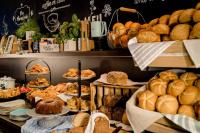 a bakery with lots of bread and pastries on display at Motel One Salzburg-Mirabell in Salzburg