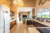a kitchen with a refrigerator and a living room at Kite Dream Cumbuco Apartments 60 &amp; 120qm in Cumbuco