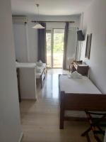 A bed or beds in a room at Filoxenia Hotel & Apartments