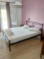 A bed or beds in a room at Filoxenia Hotel & Apartments