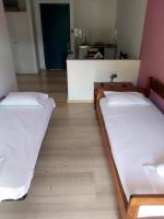 A bed or beds in a room at Filoxenia Hotel & Apartments
