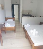A bed or beds in a room at Filoxenia Hotel & Apartments