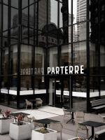 a building with tables and chairs in front of it at Mint House Dallas - Downtown in Dallas