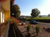 a car parked in front of a building with flowers at Knüllhotel Tann-Eck in Knüllwald