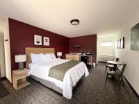 a hotel room with a large bed and a table at The Nomad Motel - International Falls, MN - Near Canadian Border in International Falls