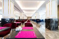 a dining room with pink tables and chairs at Granada Luxury Red Adult Only in Alanya