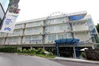 a large building with blue scaffolding around it at Beat Hotel Bangkok in Bangkok