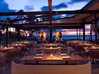 a restaurant with tables and chairs and a view of the ocean at Andaz Maui at Wailea Resort - A Concept by Hyatt in Wailea