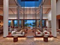a lobby with white furniture and large glass windows at Andaz Maui at Wailea Resort - A Concept by Hyatt in Wailea