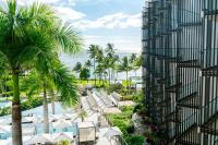 a view of a resort with a pool and palm trees at Andaz Maui at Wailea Resort - A Concept by Hyatt in Wailea