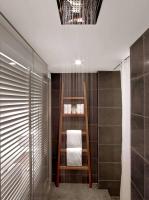 a bathroom with a towel shelf and a shower at Andaz Maui at Wailea Resort - A Concept by Hyatt in Wailea