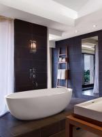 a large white tub in a bathroom with black tiles at Andaz Maui at Wailea Resort - A Concept by Hyatt in Wailea