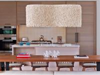 a kitchen with a wooden table and a large chandelier at Andaz Maui at Wailea Resort - A Concept by Hyatt in Wailea