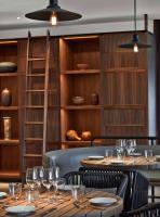 a restaurant with wooden tables and wine glasses at Andaz Maui at Wailea Resort - A Concept by Hyatt in Wailea