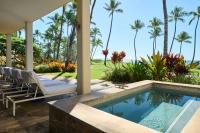a villa with a swimming pool and palm trees at Andaz Maui at Wailea Resort - A Concept by Hyatt in Wailea