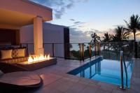 a patio with a fireplace next to a swimming pool at Andaz Maui at Wailea Resort - A Concept by Hyatt in Wailea