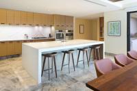 a kitchen with a large island with bar stools at Andaz Maui at Wailea Resort - A Concept by Hyatt in Wailea