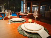 einem Holztisch mit zwei Gläsern und Platten darauf in der Unterkunft Almareia Boutique Hotel in Praia dos Carneiros