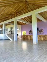 a large room with wooden ceilings and wooden tables at MisBHaven Resort and Spa in Port Antonio