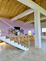 a room with a staircase and a table with chairs at MisBHaven Resort and Spa in Port Antonio