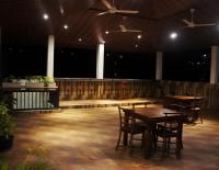 a patio with tables and chairs in a building at Ark Cabin Villa in Kandy